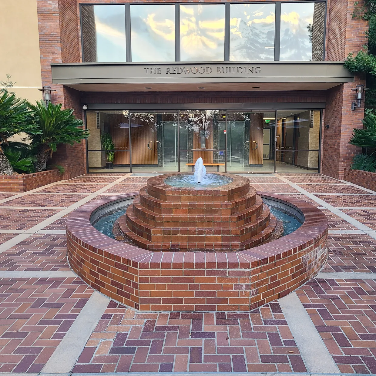 The Spanish Language Center campus, the Redwood Building entrance and its brick courtyard fountain in San Diego.